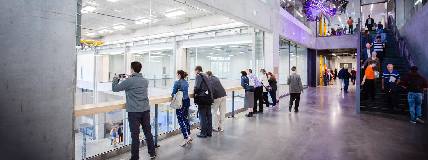People exploring and taking pictures inside the STEM building