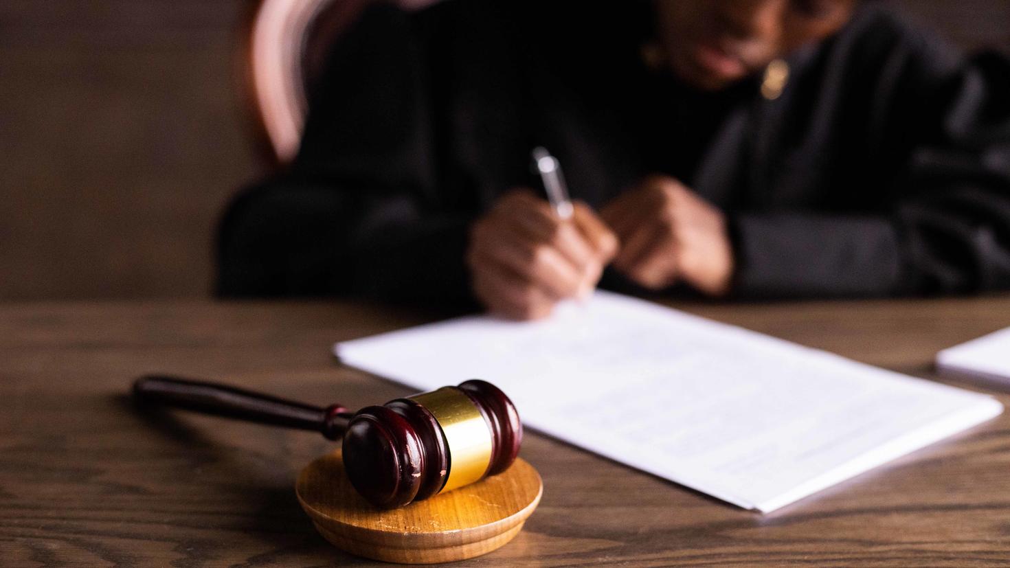 A gavel is placed in front of a judge.
