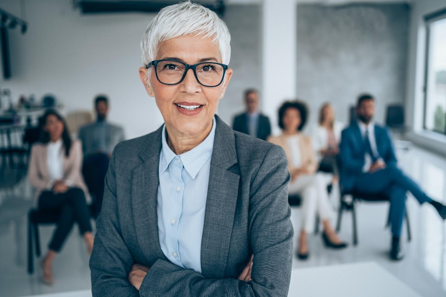 A woman standing in front of the room