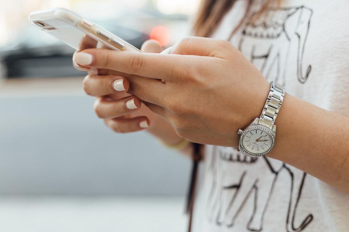 Woman's hands using cell phone