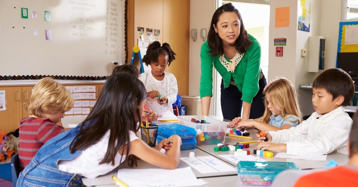 A teacher playing with her students