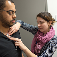 Woman applying electrodes on a subject.