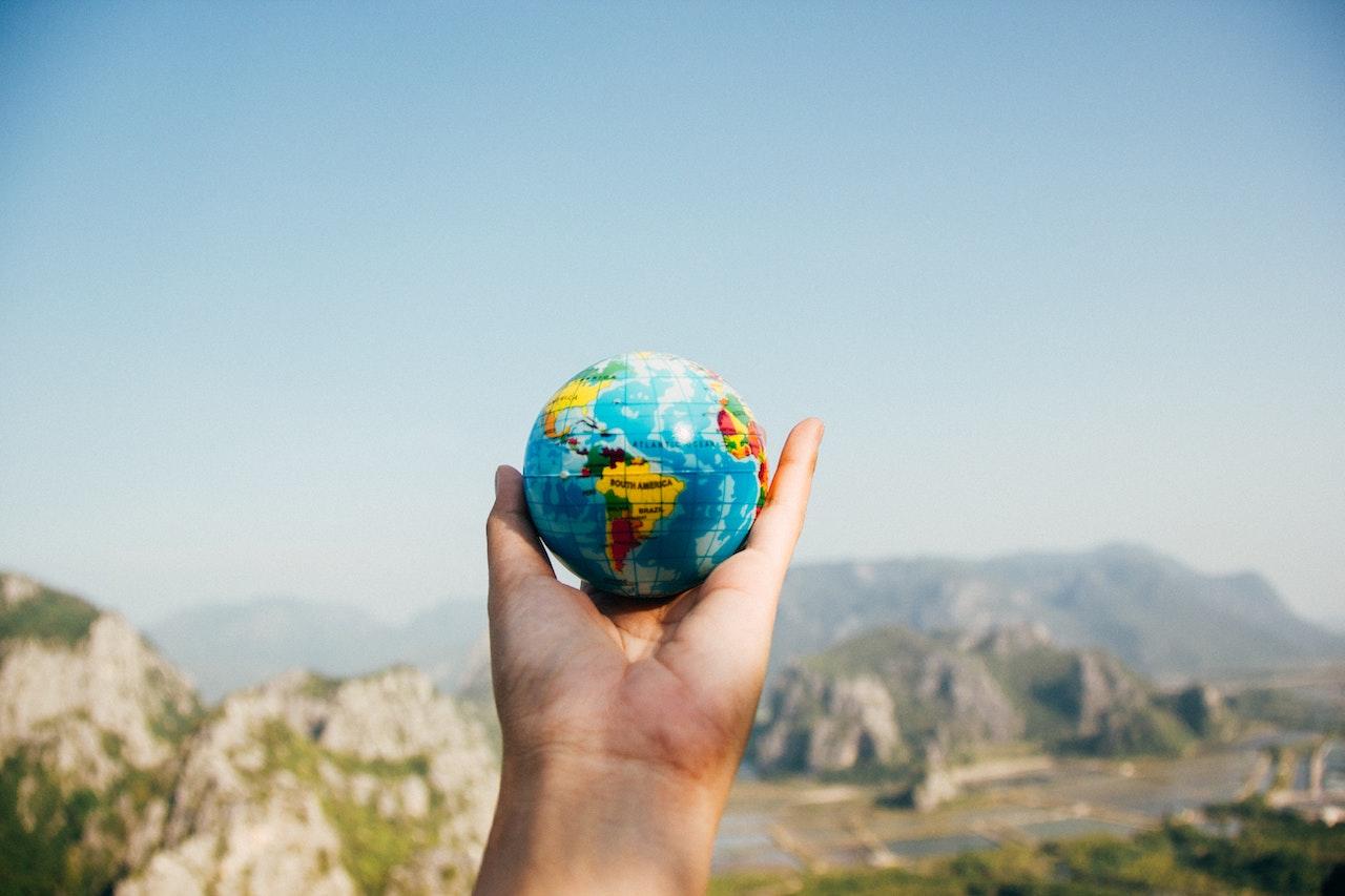 A hand handing the world