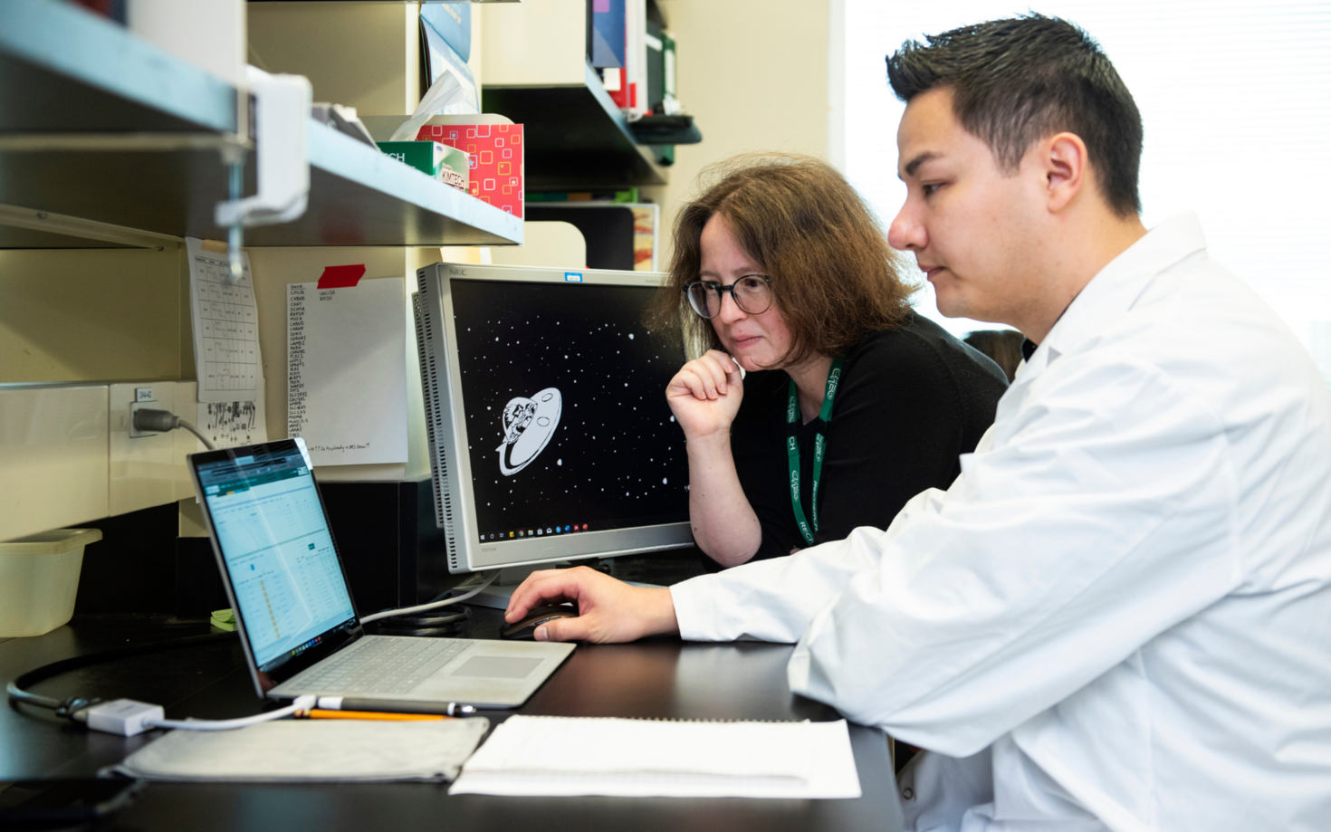 Researchers analyzing data on computer.
