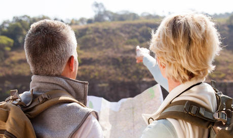 Two people on a hike looking out and the view.
