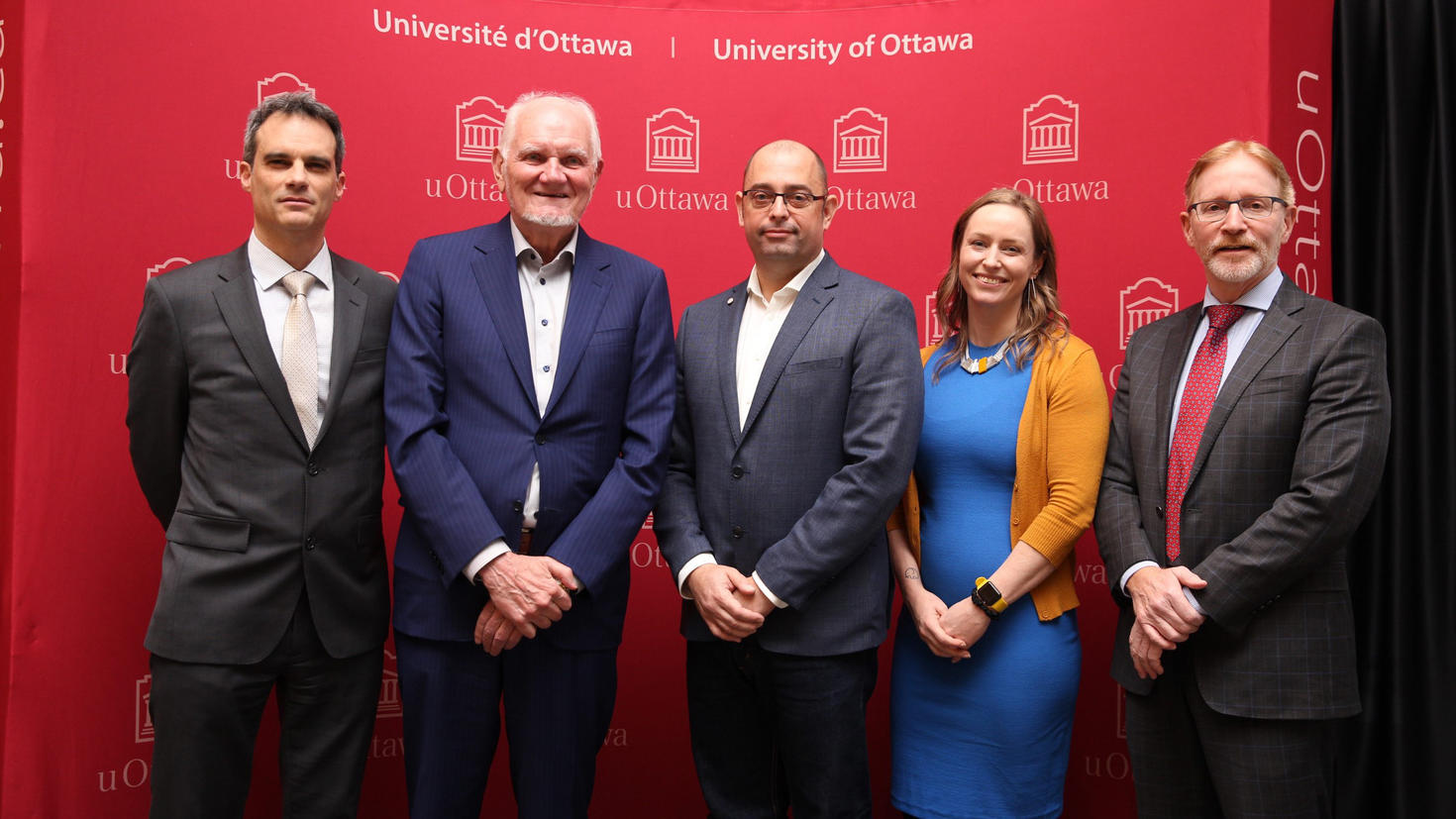 five people stand together for a photo.