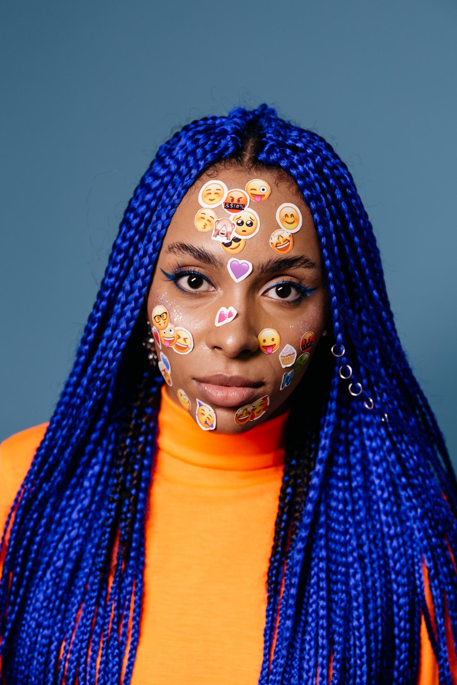 Woman with emoji stickers on her face