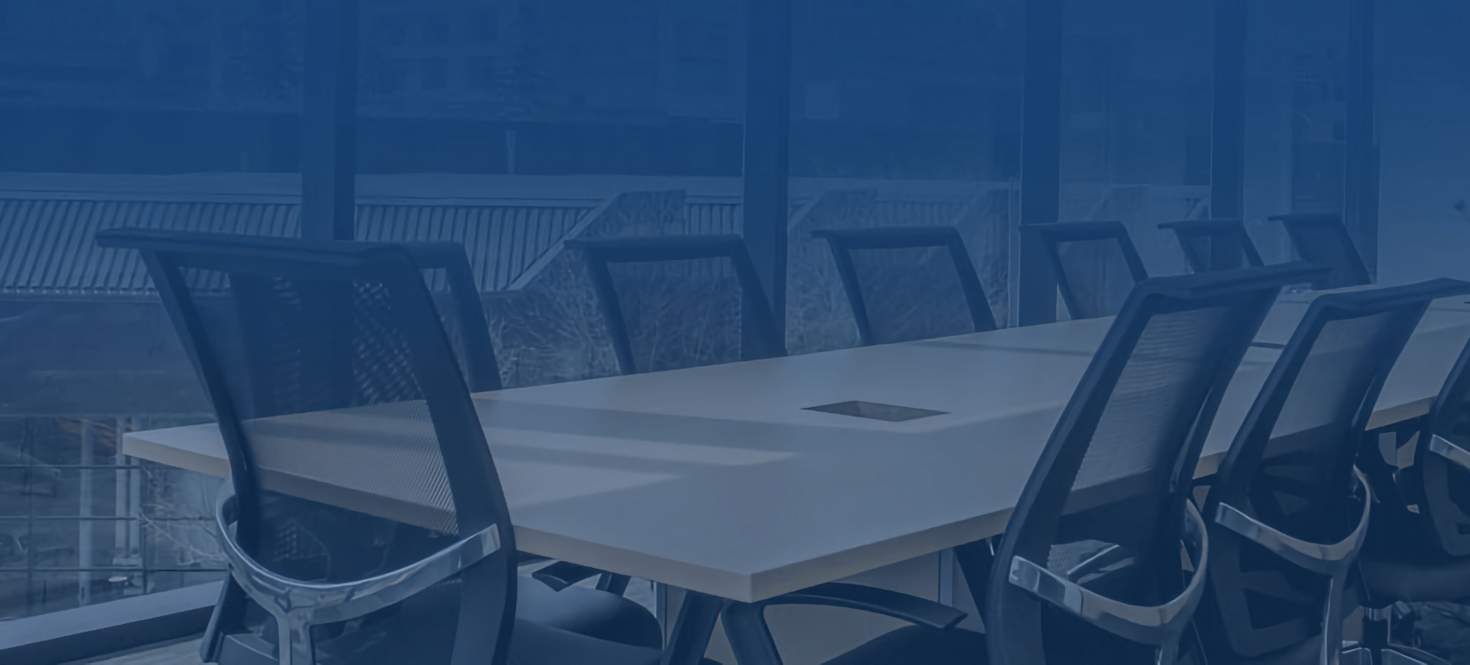 An image of a meeting room table and chairs