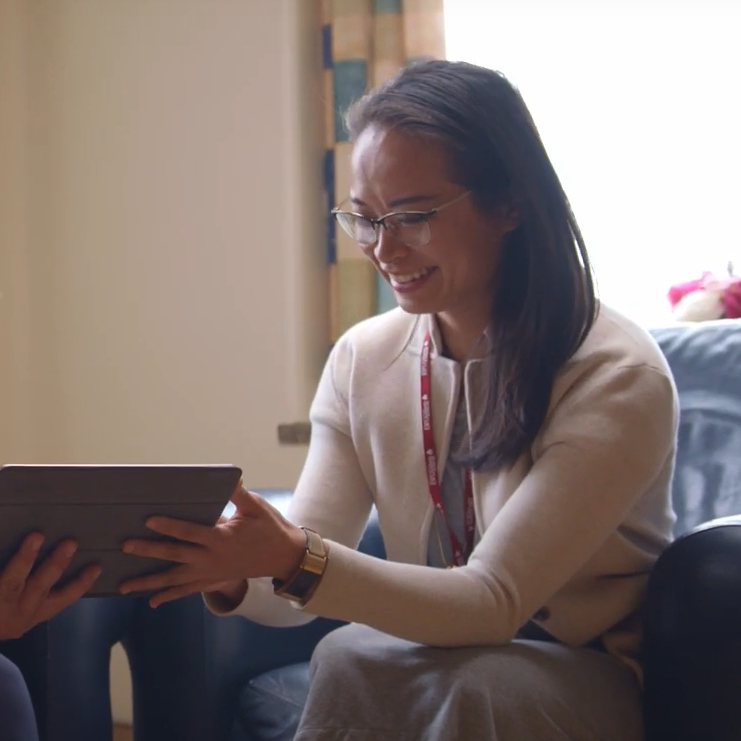 Dr. Amy Hsu smiling and holding an iPad.