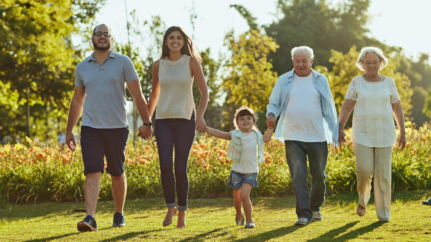 Five people walking together while holding hands