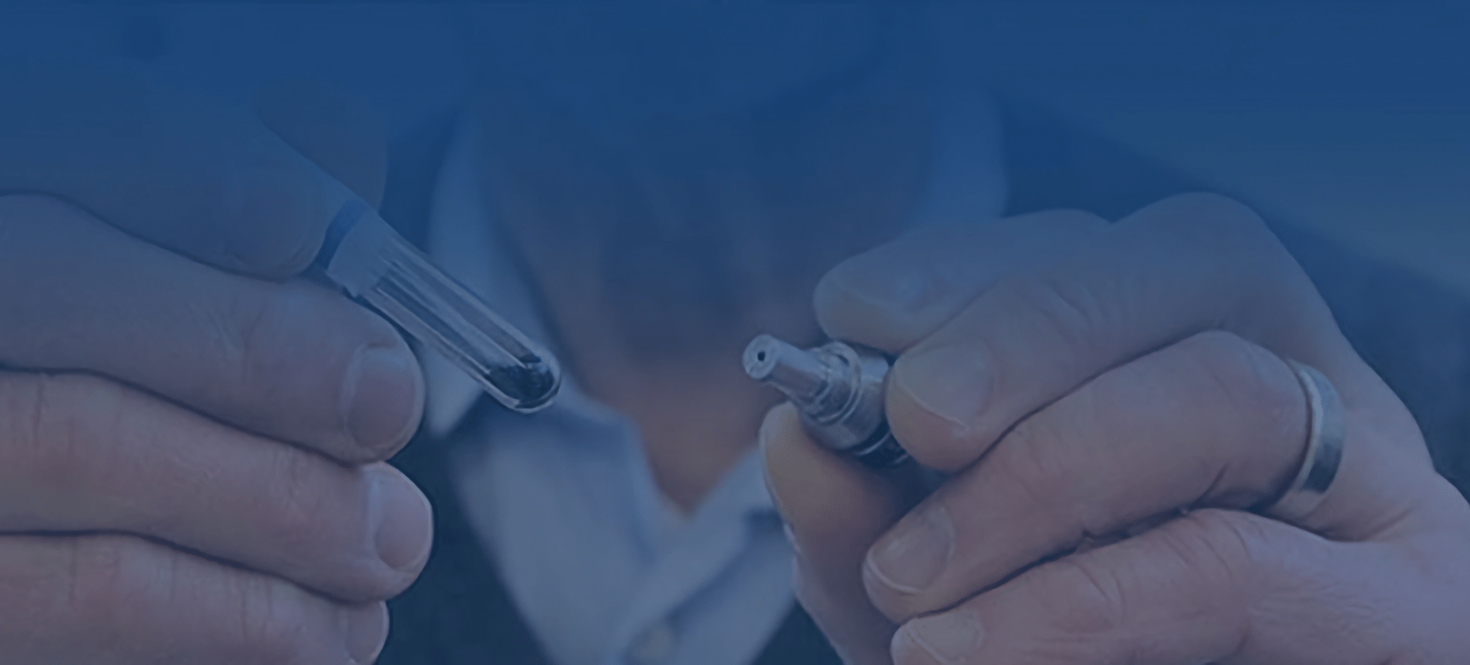 A close of hands holding two items from the lab