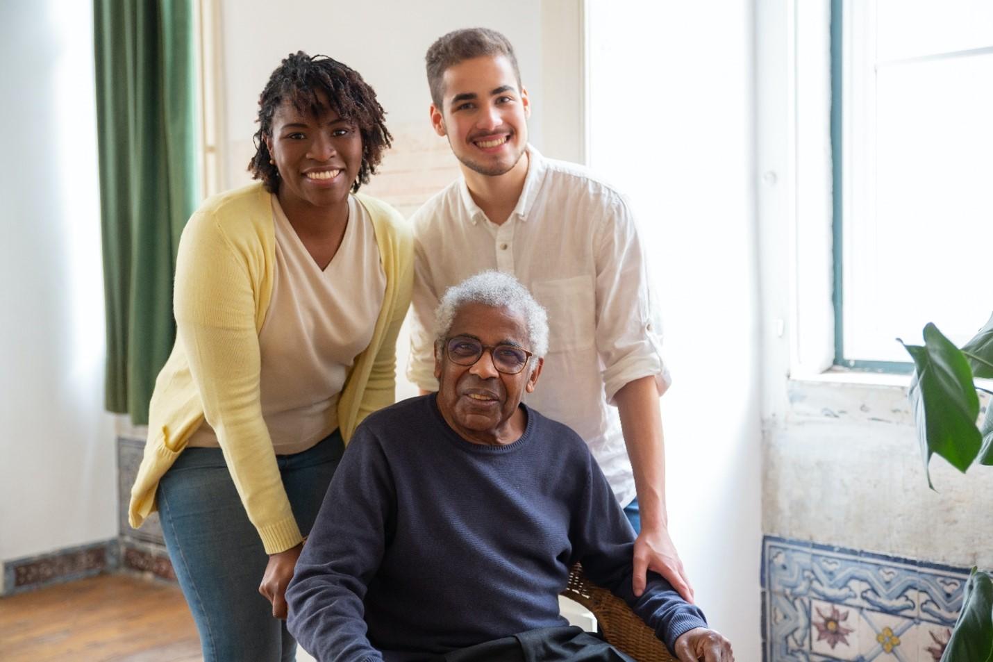 Elderly man with two young people