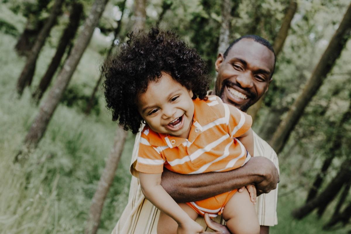 Black father and son playing
