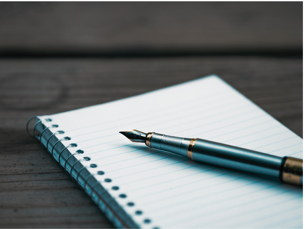 Lined notebook with pen. 