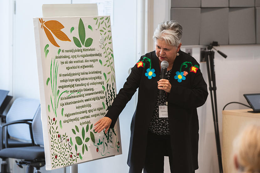Claudette Commanda reads the wording on a tapestry.