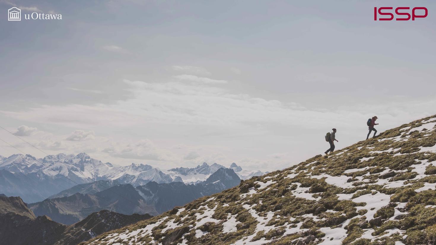 Two people climbing a mountain. 