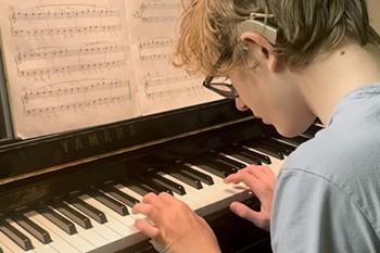 Boy playing piano