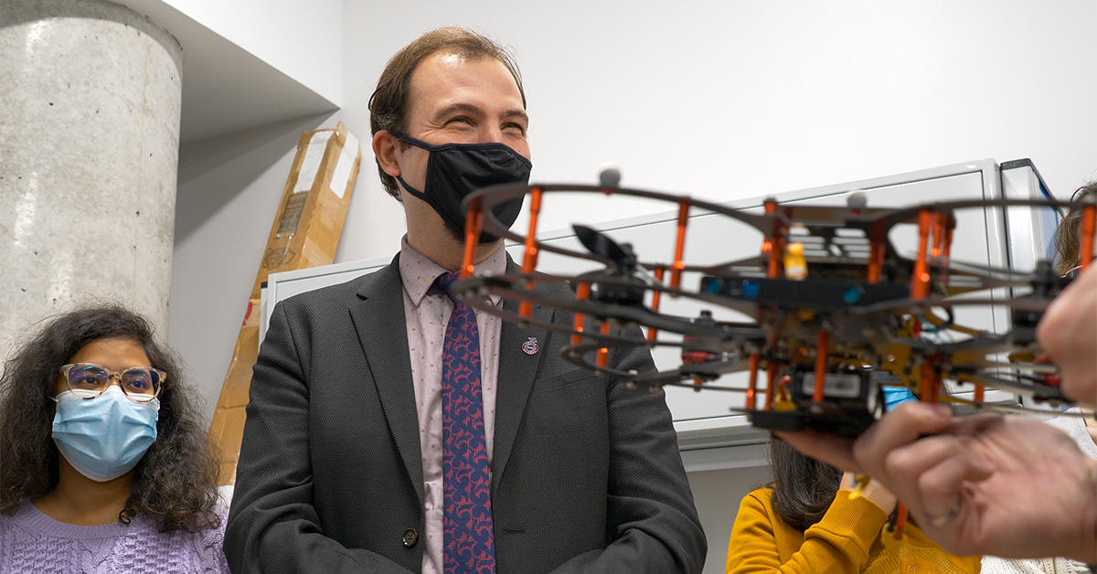 Professor Burak Kantarci and students with a drone