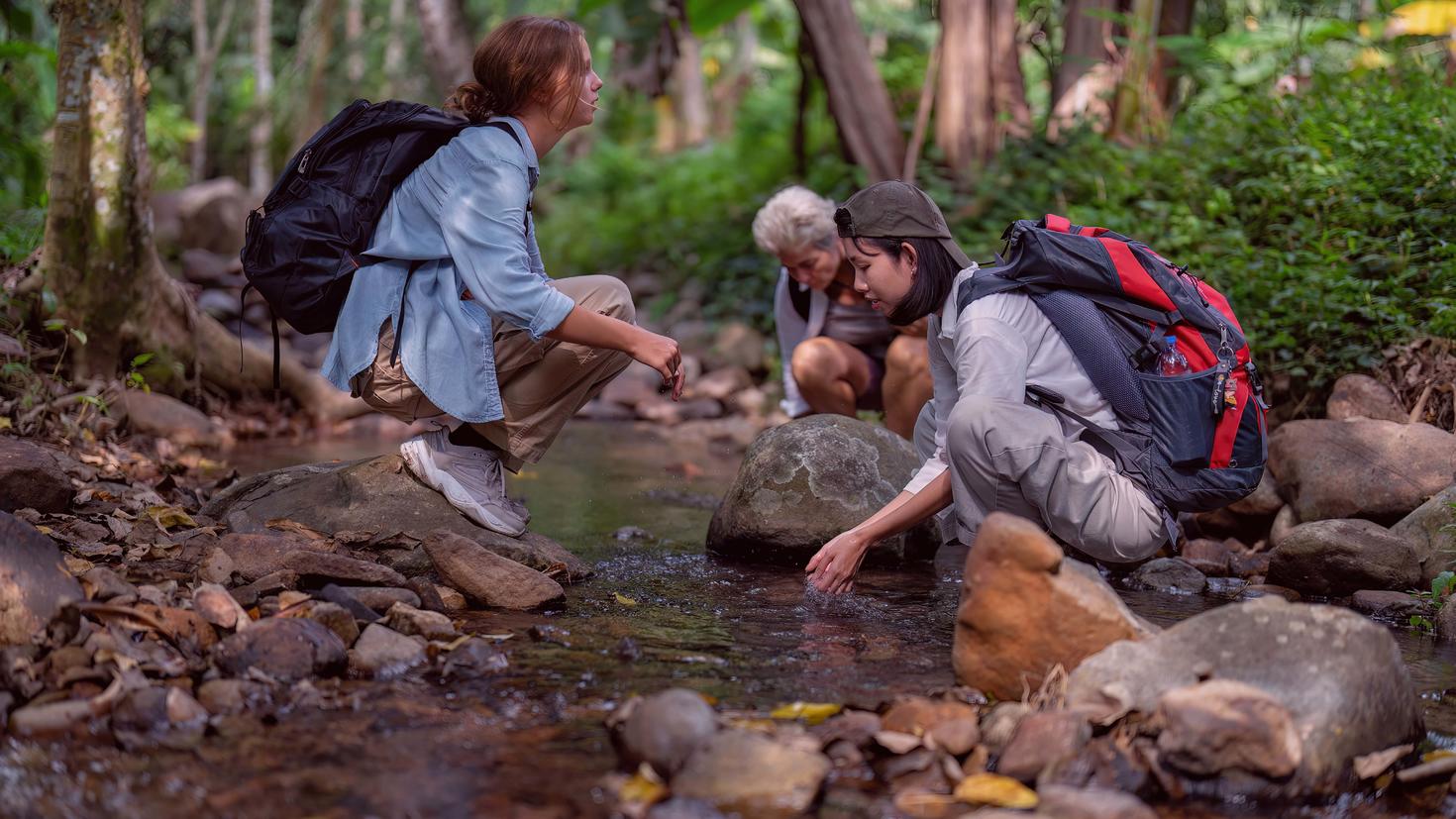 three backpackers in nature