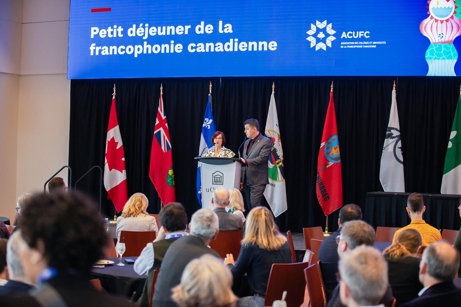 Two speakers at a podium during the breakfast