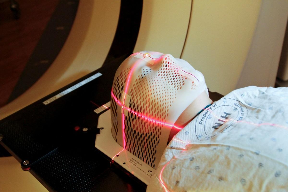 Person undergoing brain cancer radiation treatment