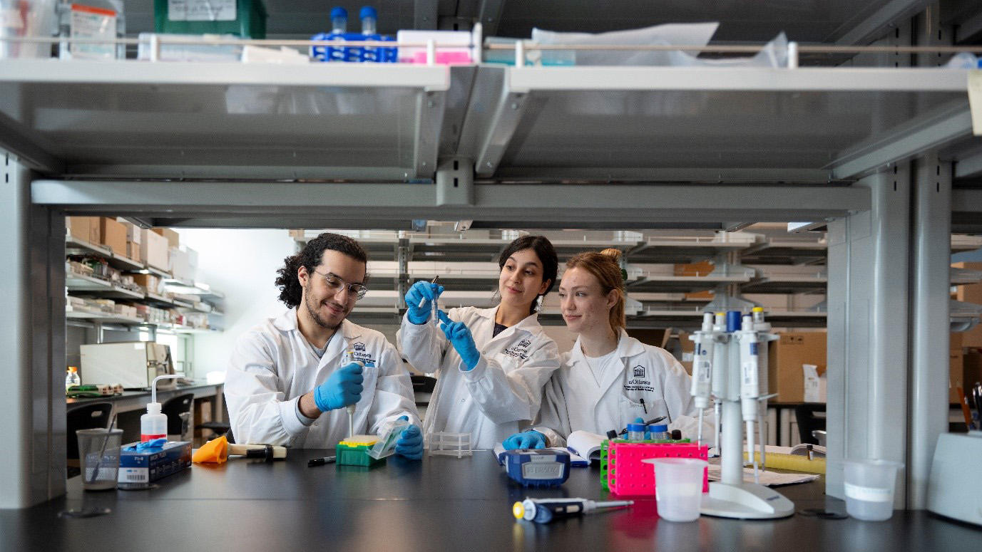 Three students making experiment