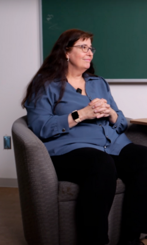 Prof Andra Smith sitting on a chair