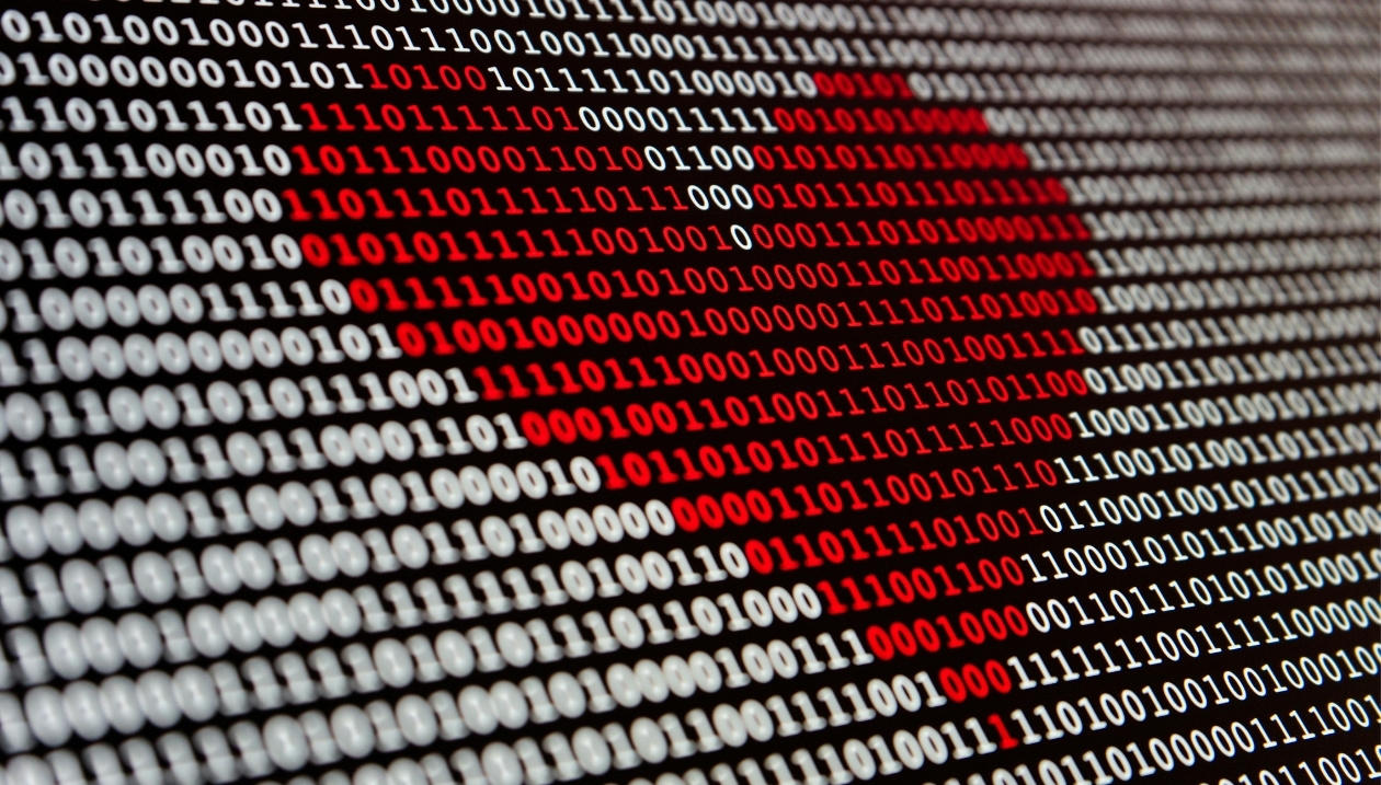 Heart drawn over binary code.