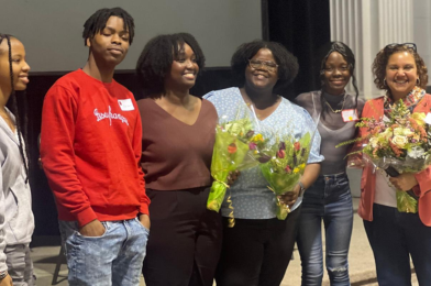 Senator Bernadette Clément (right) and clinical psychology doctoral candidates Wina Darius and Grace Jacob (centre) hold bouquets of flowers and pose with three students during the “My mental health, my family and me”  event at the University of Ottawa.