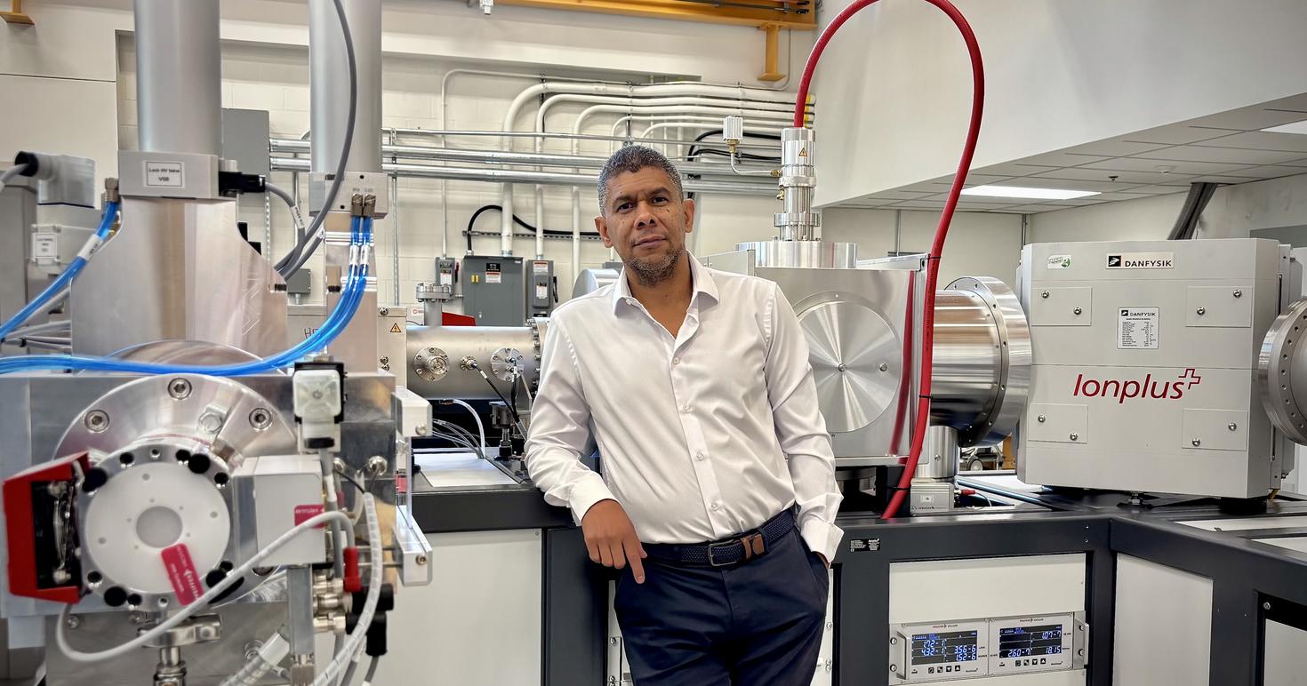 Dr. Gary Salazar standing in front of the Mini Carbon Dating System
