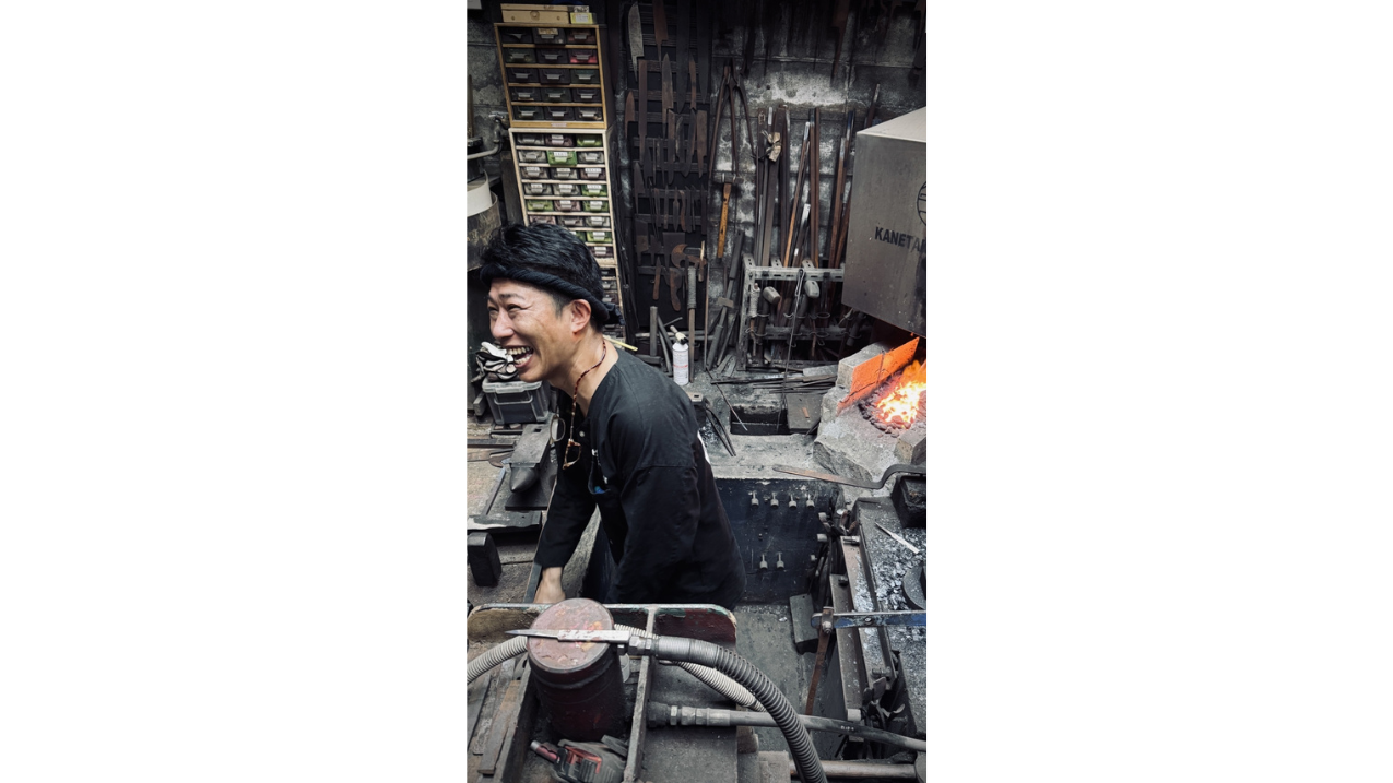 Yoshitaka Yamada, seventh-generation blacksmith, giving a demonstration of Japanese knife making in his workshop.