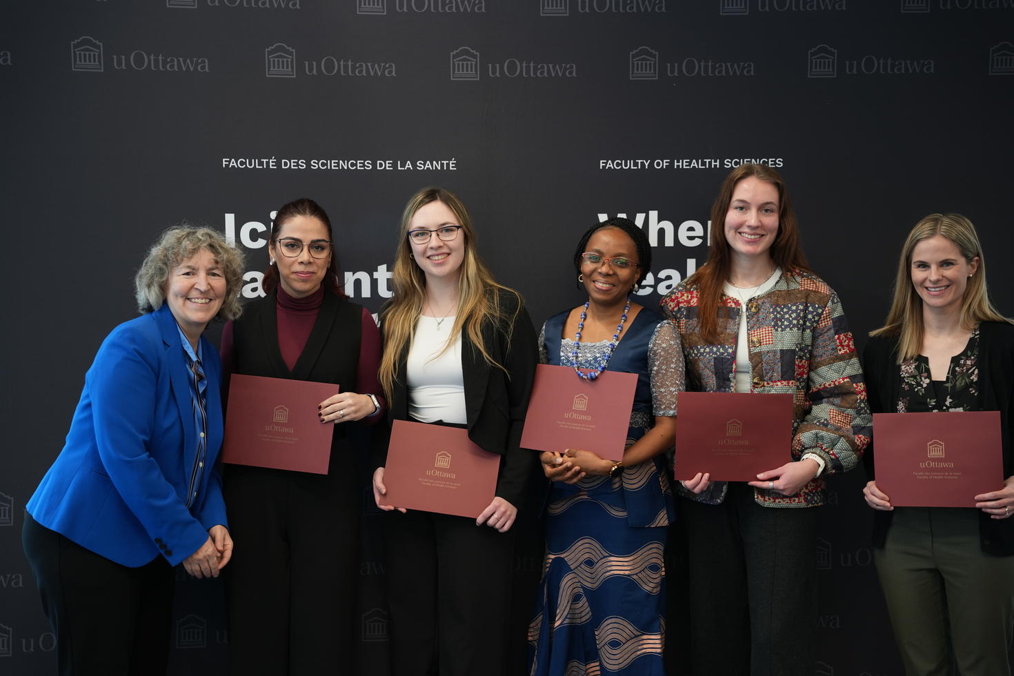 Graduate students receiving an award from Dean Lucie Thibault