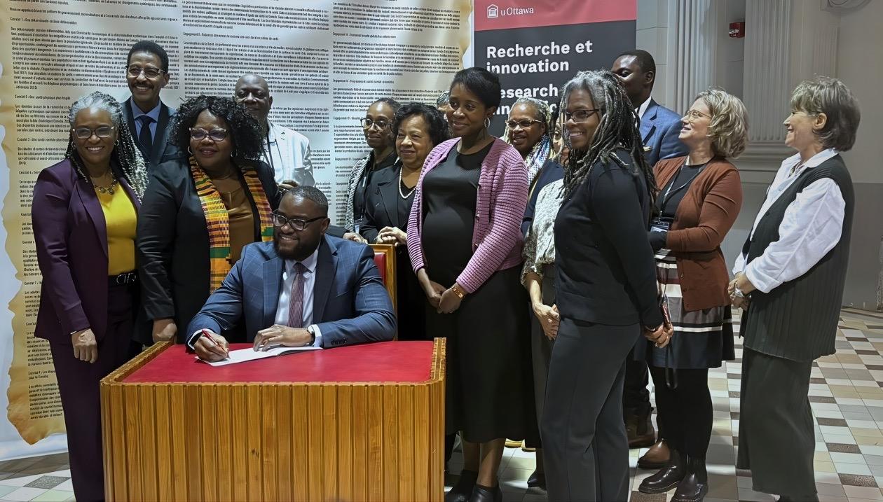 Researchers and politicians huddled around the Declaration document