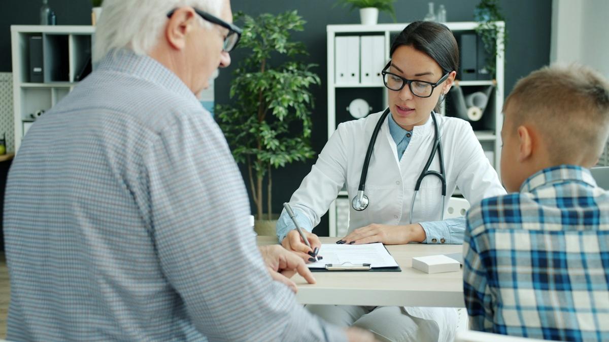 Female doctor with senior patient and child