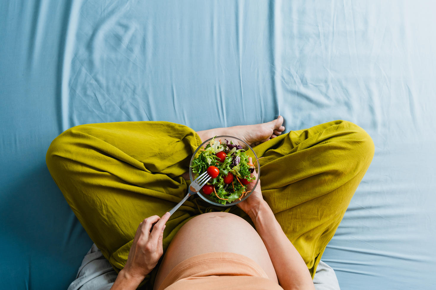 Pregnant woman eating a salad