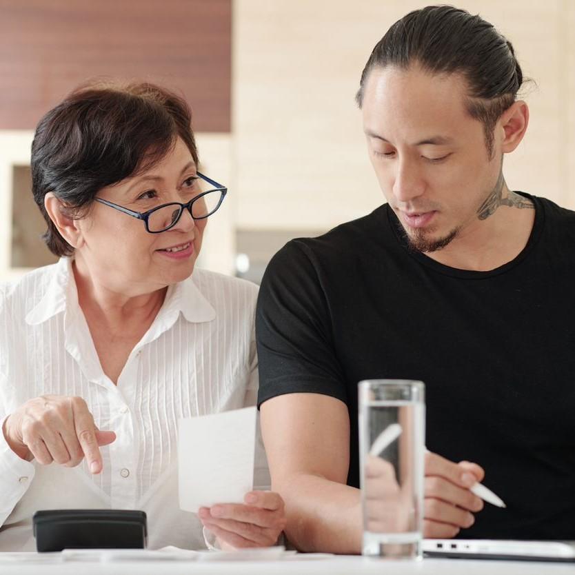 Mother and son working together with finance square
