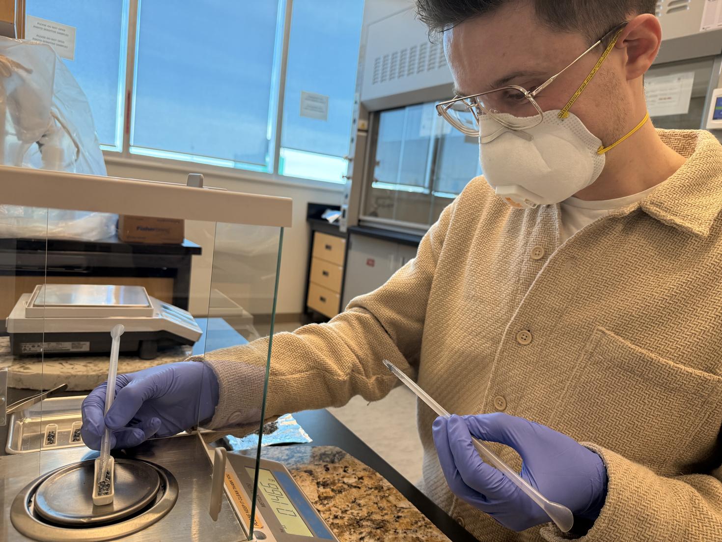 Liam Jasperse using a scale to weigh samples