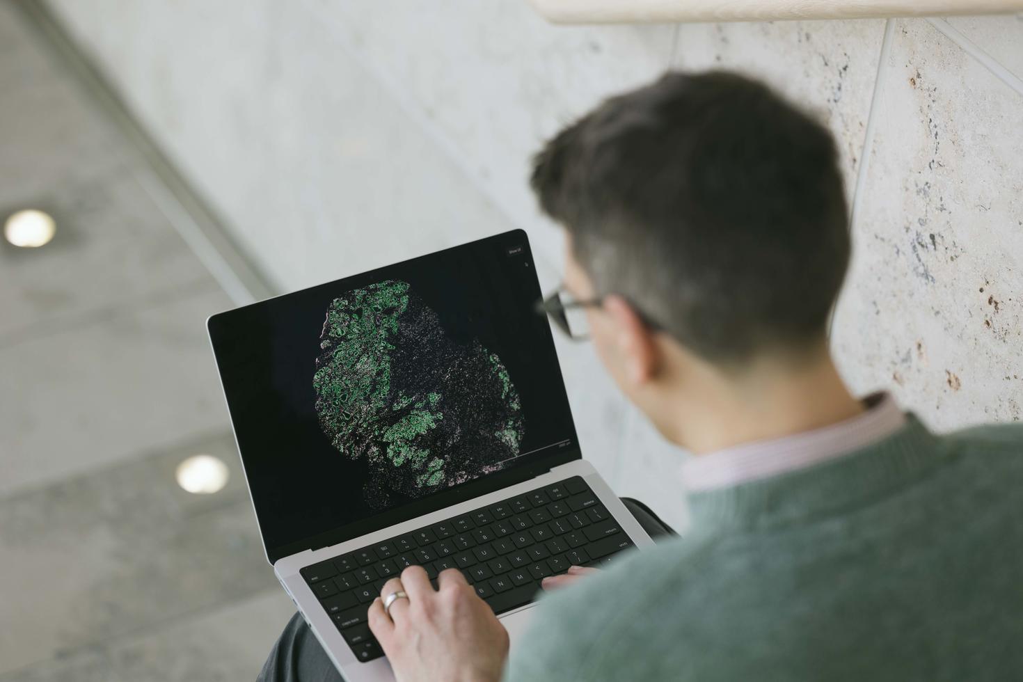 Professor David Cook analyzing a cell on his laptop 