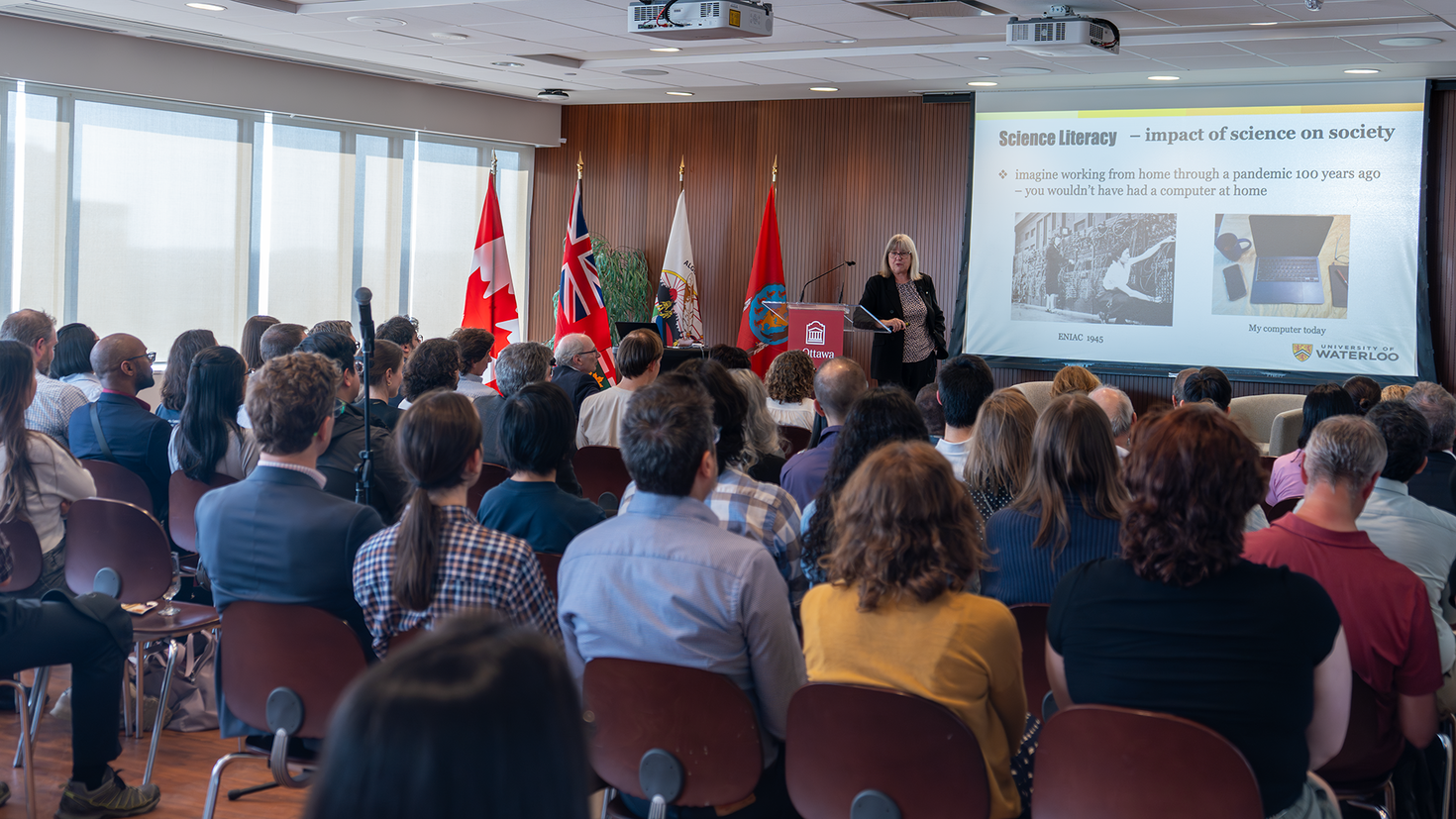 Nobel laureate Donna Strickland giving a presentation to a room full of people at the University of Ottawa.