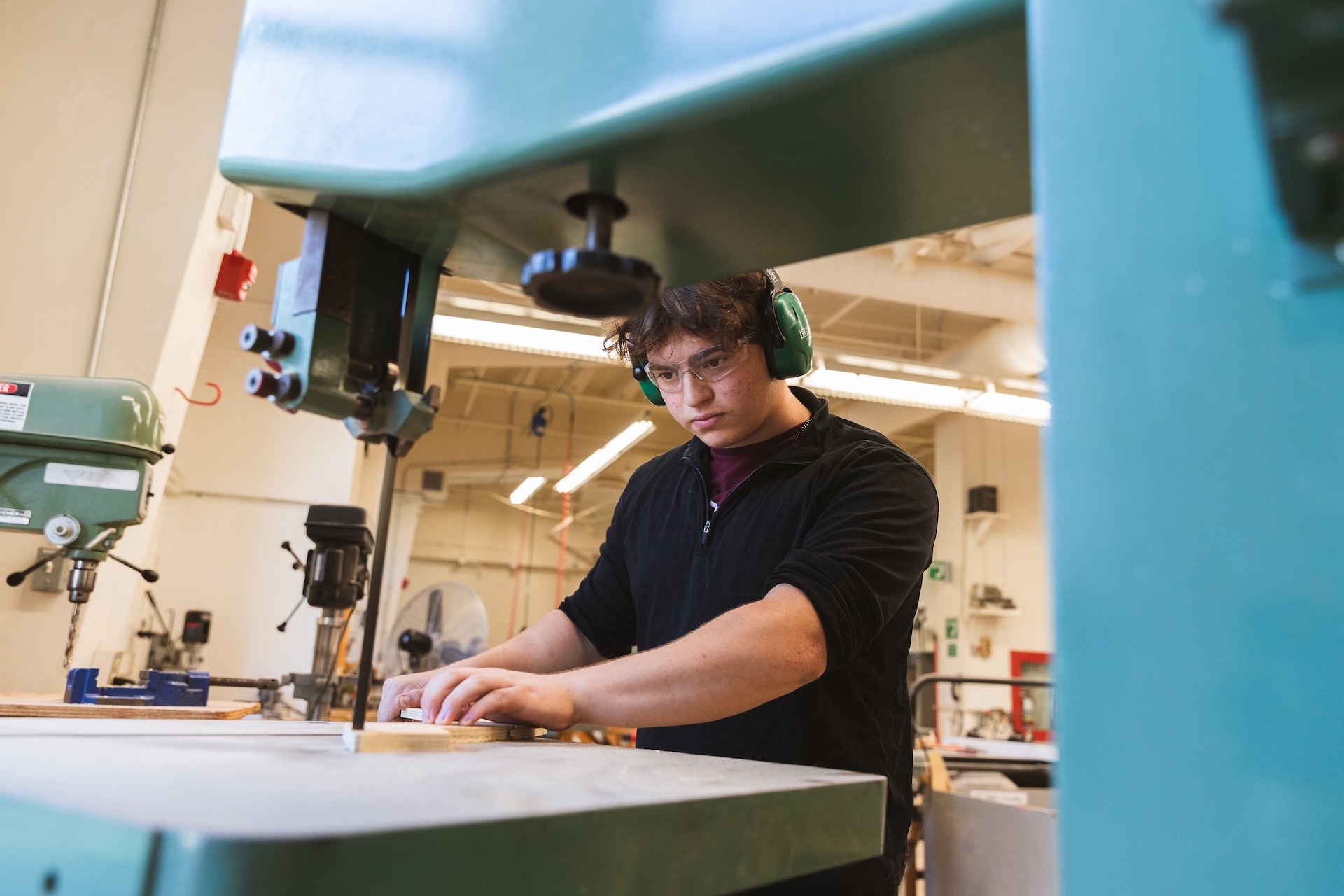 Student working on a wood piece
