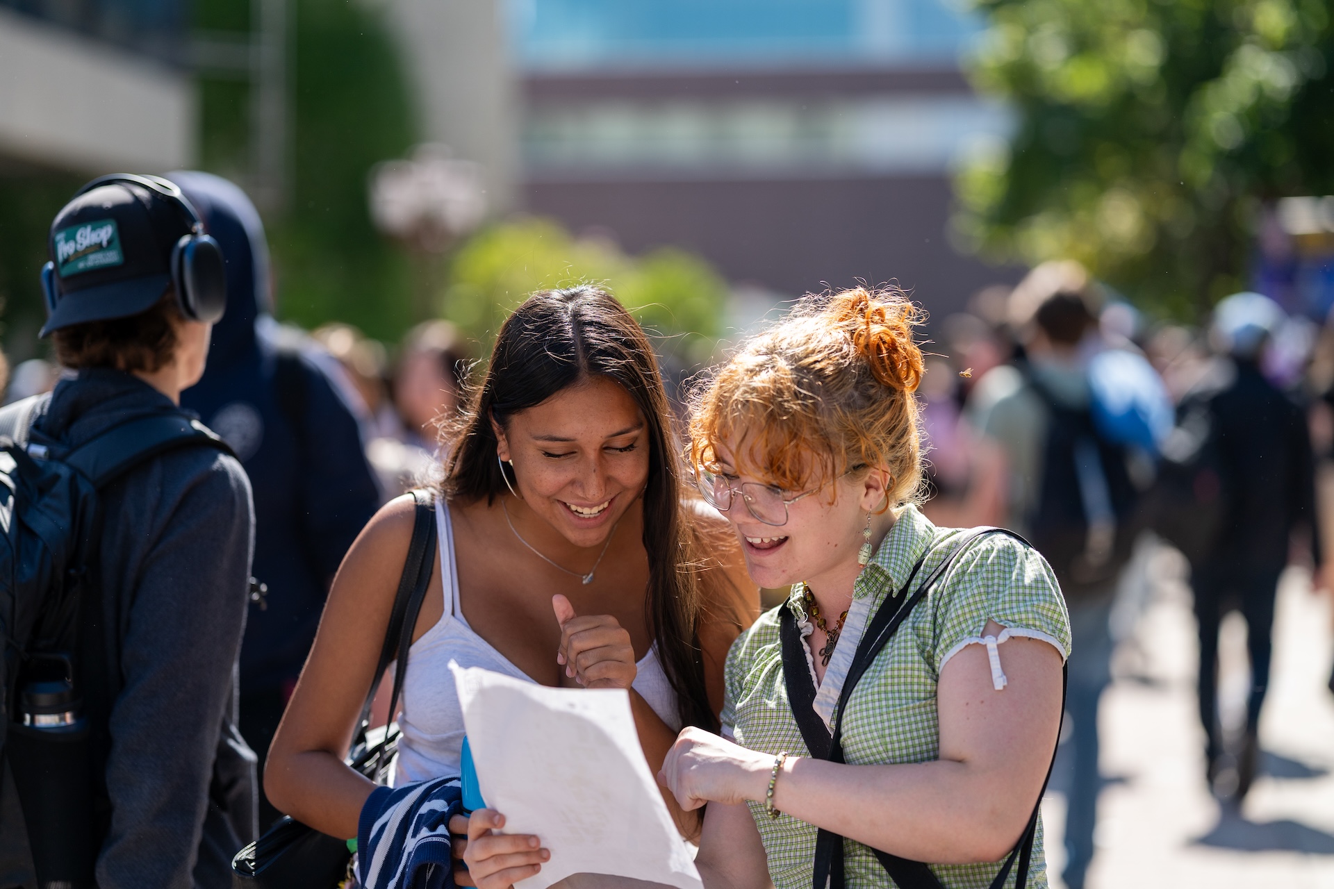 Students looking at papers and smiling