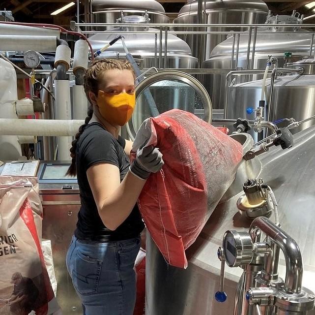 Engineering student Jade Breau working in a brewery.