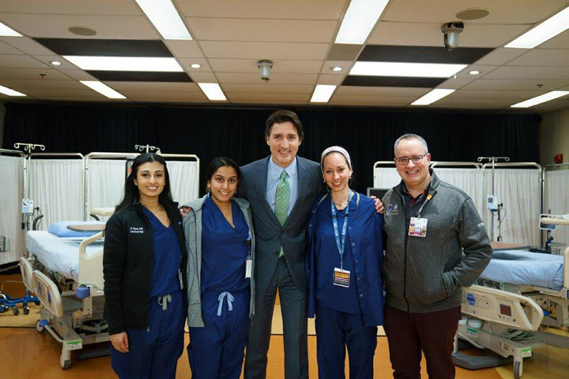Prime Minister Justin Trudeau poses with a group of people.