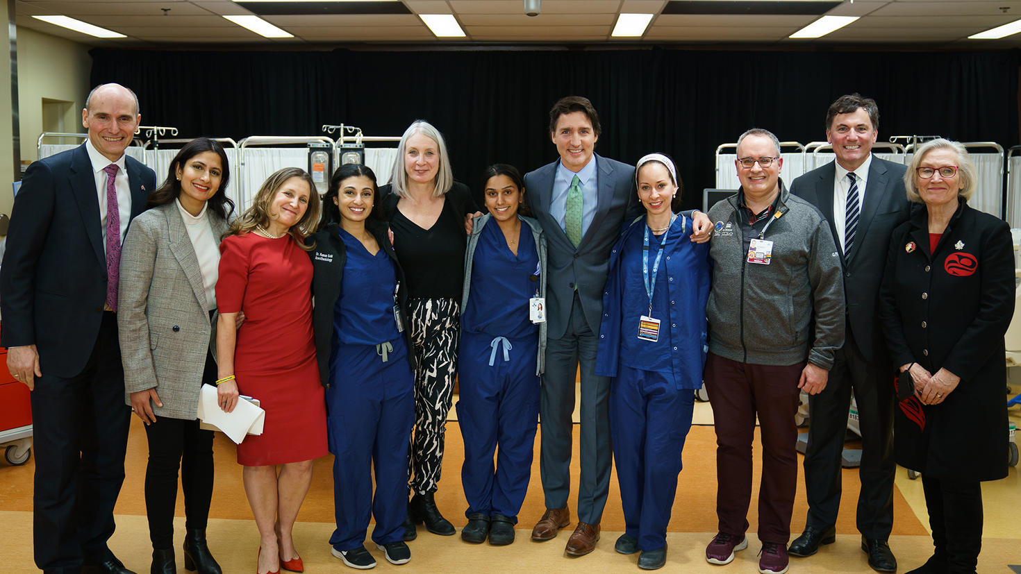A group of people pose in a row