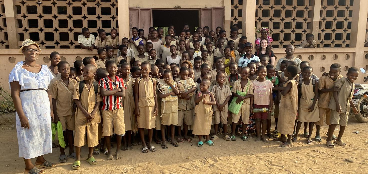 group of primary school students in front of their school in Dhassa