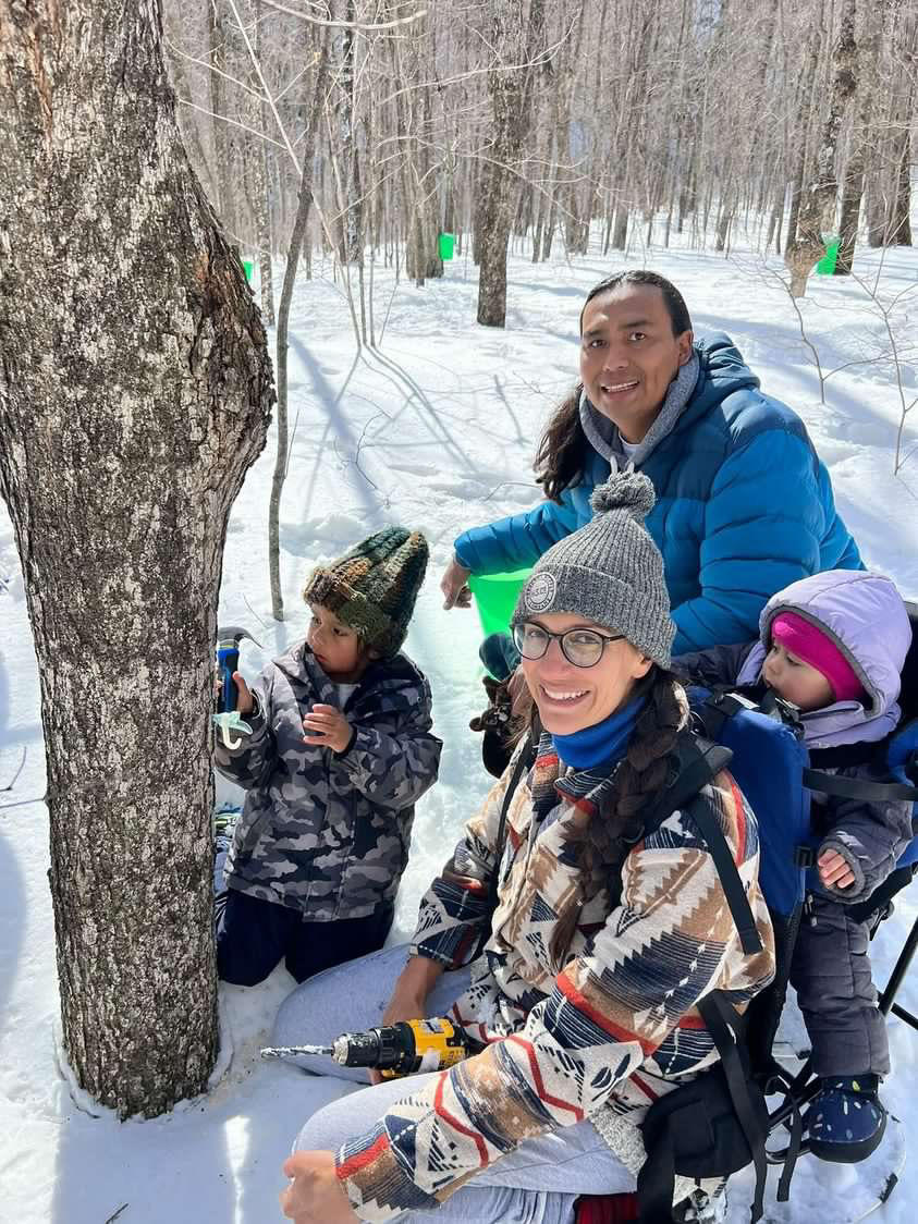 Family out tapping for maple syrup