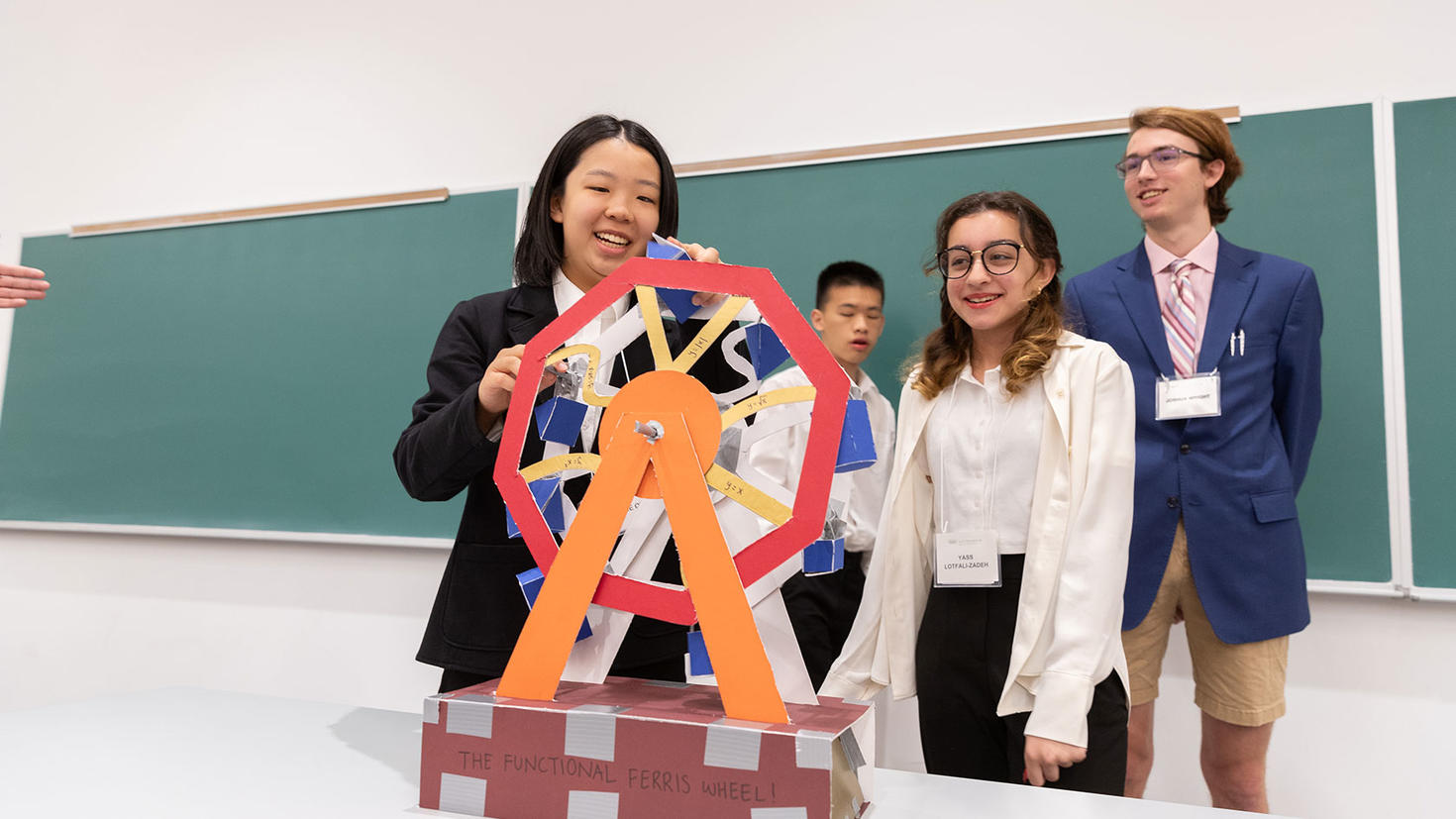 Trois élèves présentent leur projet de mathématiques. 