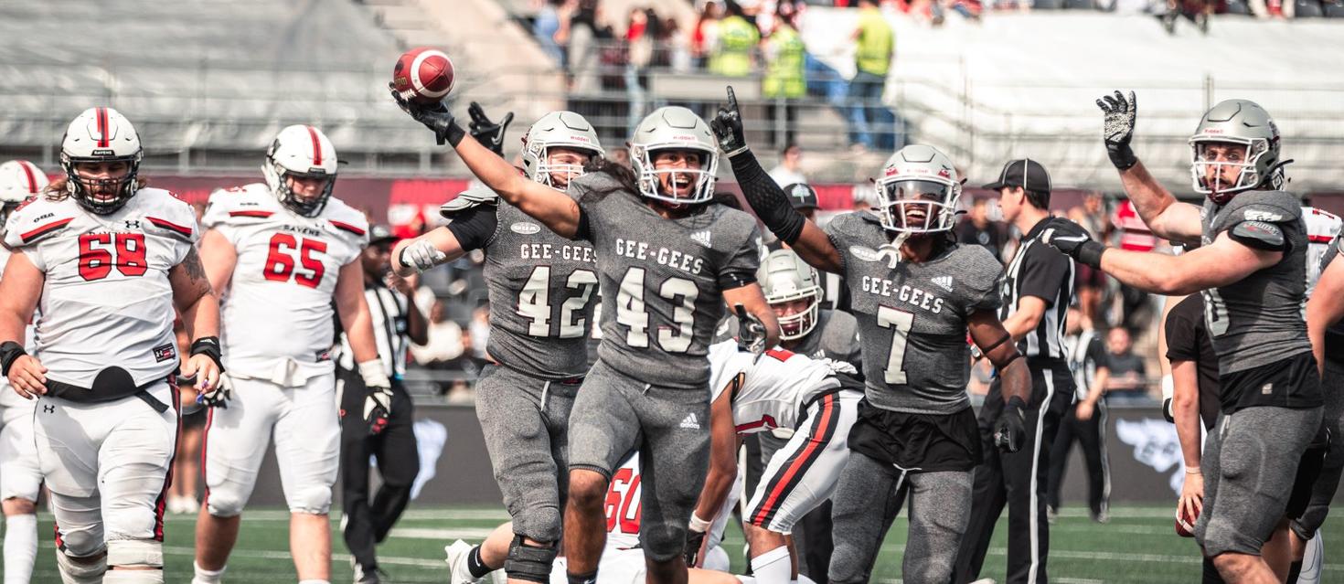 Gee-gees football players celebrating on the field