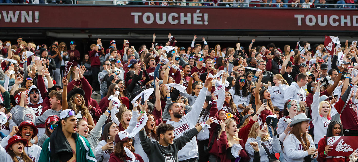 A crowd of students cheering for the Gee-Gees