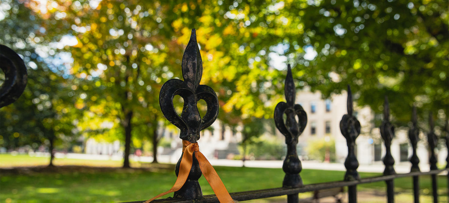 An orange ribbon tied around railing.